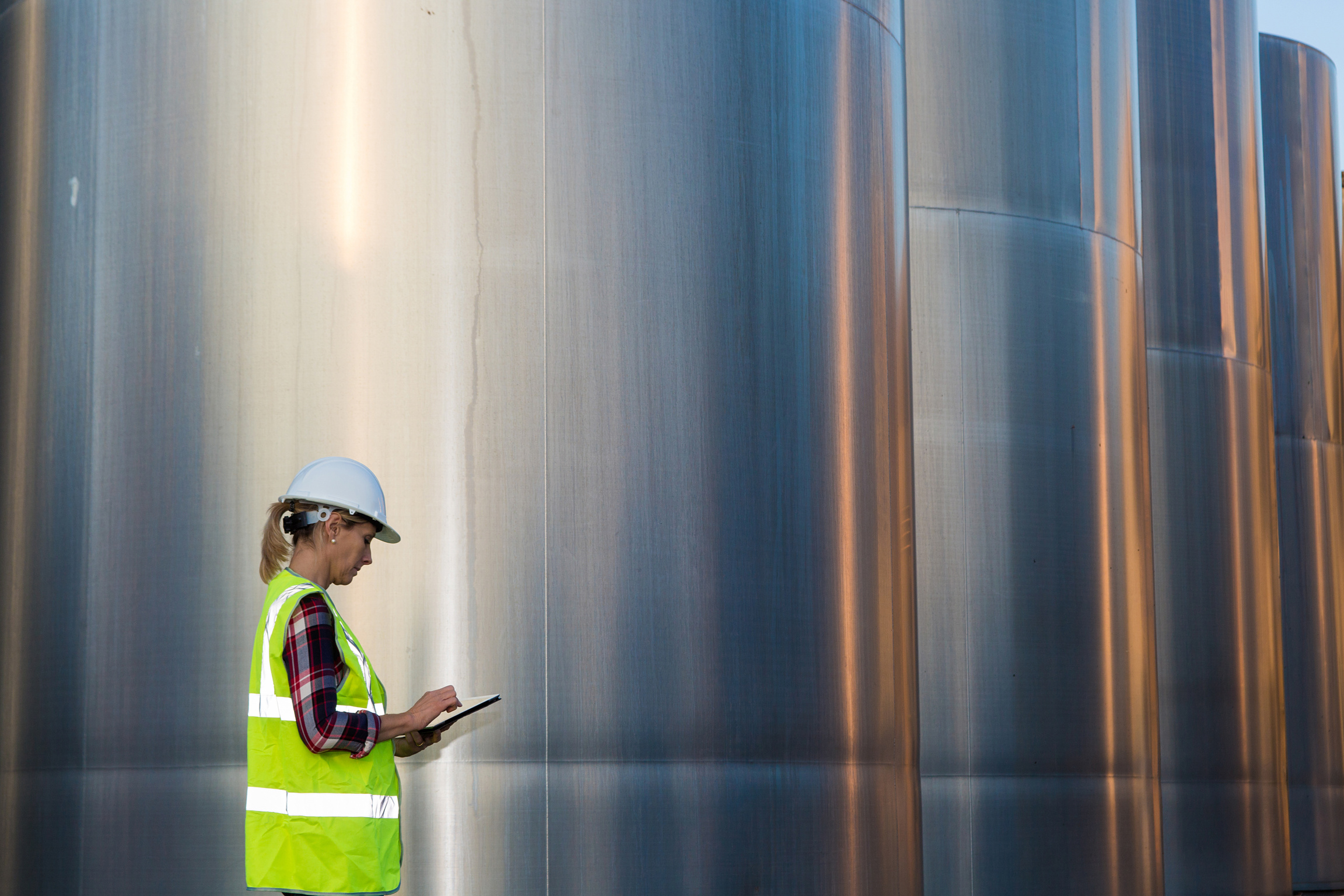 female engineer inspecting food industry installation